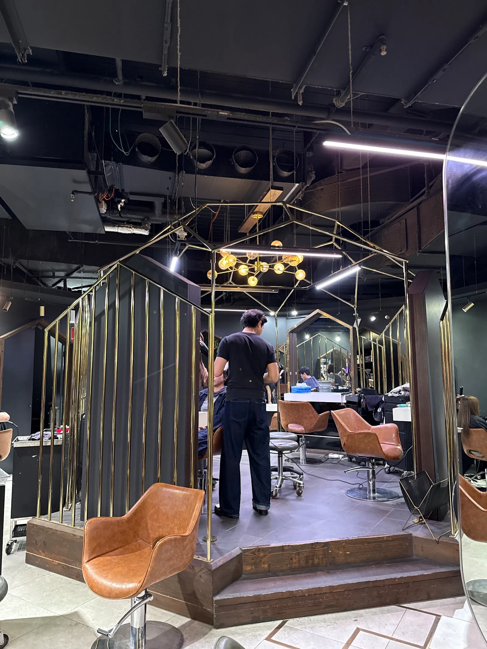 Inside the salon: styling chairs under gold-framed mirrors